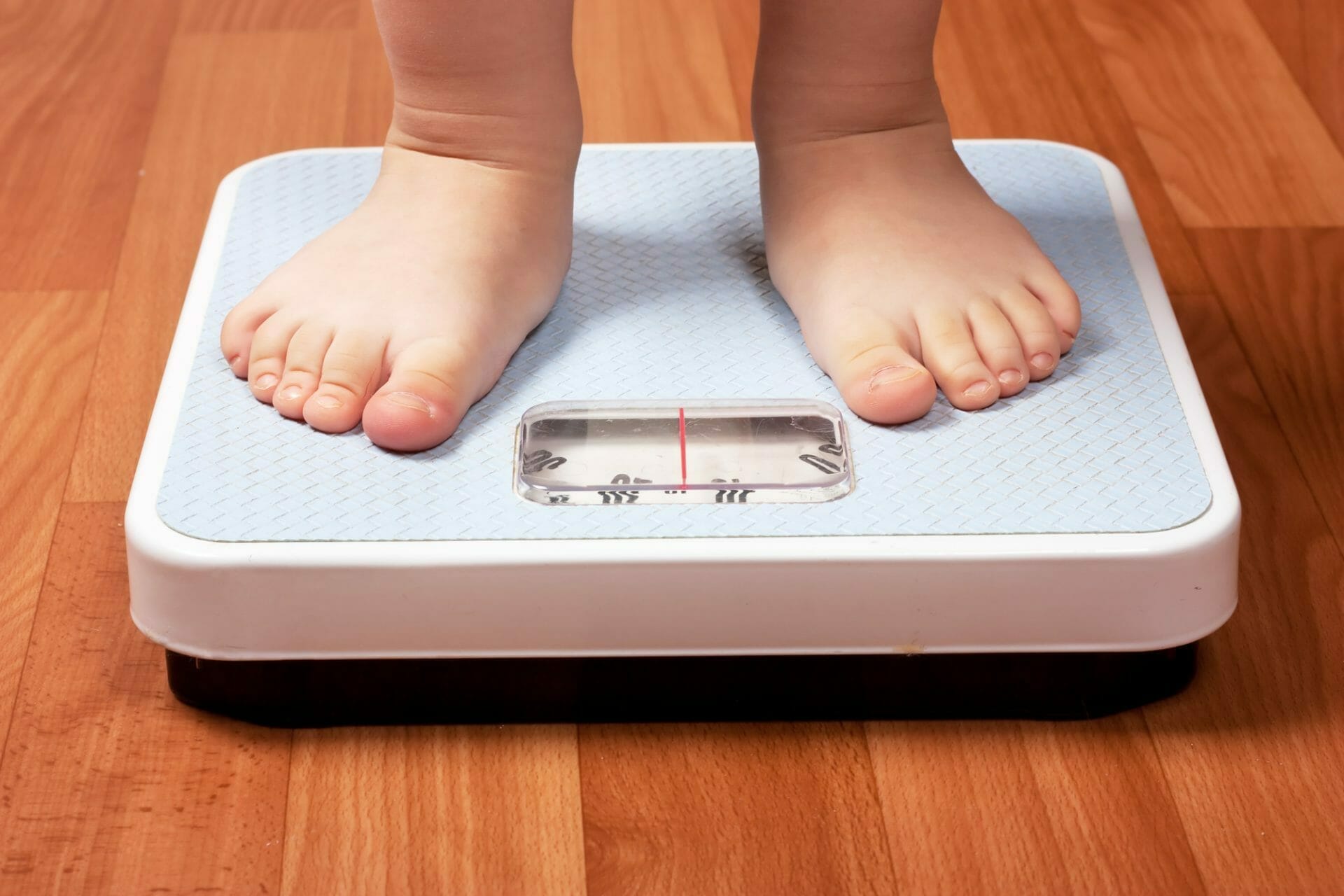 A child's feet on a weight scale.