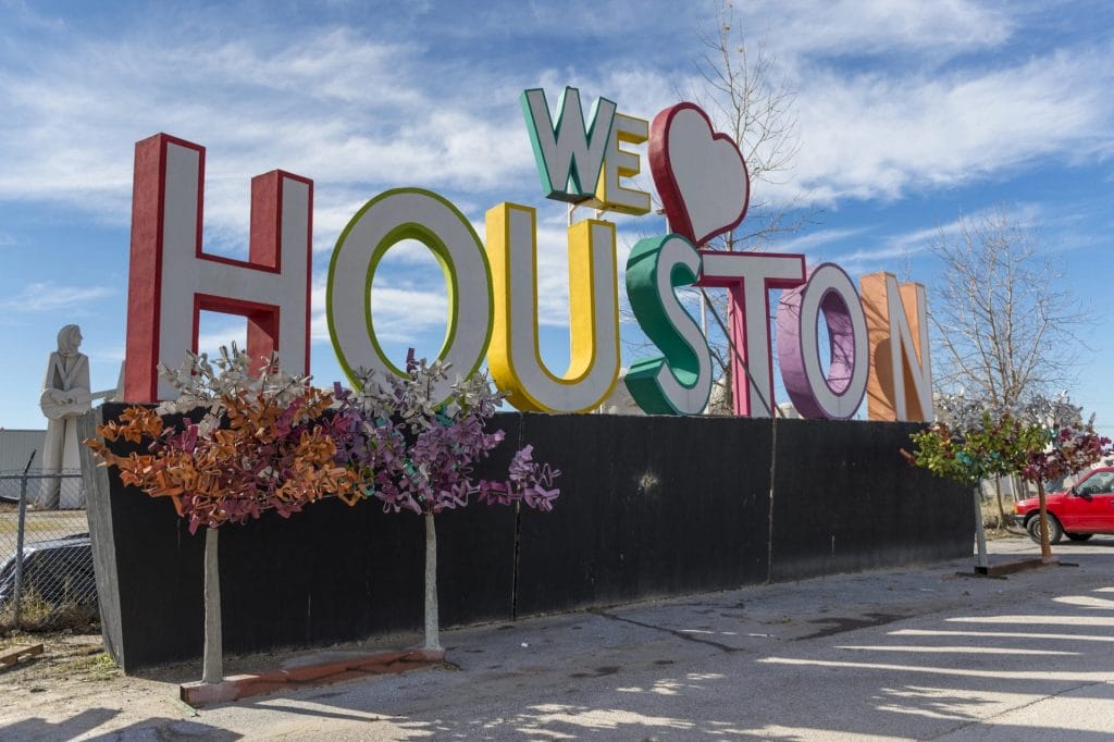 Experienced Pediatrician providing compassionate care in Houston, Texas with a love for houston sign.