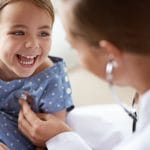 A pediatrician examining a child's health.